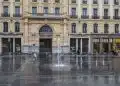 a large building with a fountain in front of it