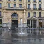 a large building with a fountain in front of it