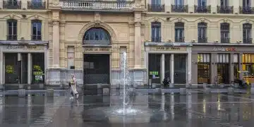 a large building with a fountain in front of it